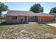 Single-story brick home with a tidy front yard, attached garage, and inviting entry at 2470 Pine Tree Circle Dr, Orange City, FL 32763