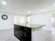 Open floor plan featuring stylish kitchen island with granite countertop, tiled base and wood-look tile flooring at 2470 Pine Tree Circle Dr, Orange City, FL 32763