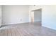 An open and airy living room showcasing wood-look tile flooring and a bright interior at 2470 Pine Tree Circle Dr, Orange City, FL 32763