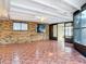 Spacious sunroom with tile flooring, brick wall and bright, natural light from outdoor access at 2470 Pine Tree Circle Dr, Orange City, FL 32763