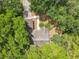 Aerial view of a charming house surrounded by lush greenery and mature trees at 2647 Lake Landing Blvd, Eustis, FL 32726