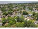Beautiful aerial view of a neighborhood with mature trees, several pools, and a lake in the distance at 2647 Lake Landing Blvd, Eustis, FL 32726