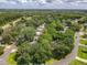 Aerial view of a quiet residential area with tree-lined streets, single-Gathering homes, and easy access to the highway at 2647 Lake Landing Blvd, Eustis, FL 32726