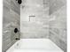 Modern bathroom with marble tiling and a shower niche for storage of toiletries and bath products at 2647 Lake Landing Blvd, Eustis, FL 32726