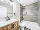 Modern bathroom with a marble-tiled shower, a wooden vanity, and black and white floor tiling at 2647 Lake Landing Blvd, Eustis, FL 32726
