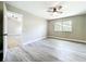 Bright bedroom featuring wood-look flooring, a ceiling fan, and natural light from the window at 2647 Lake Landing Blvd, Eustis, FL 32726