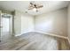 Bedroom with wood-look flooring, a closet, ceiling fan, a window, and a doorway for easy living at 2647 Lake Landing Blvd, Eustis, FL 32726