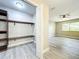 Bedroom closet features custom wood shelving for optimal storage space and organization at 2647 Lake Landing Blvd, Eustis, FL 32726