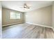 Bedroom featuring a ceiling fan, wood floors and a bright window at 2647 Lake Landing Blvd, Eustis, FL 32726