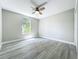 Bright bedroom featuring a ceiling fan and a window allowing ample natural light at 2647 Lake Landing Blvd, Eustis, FL 32726