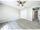 This bedroom features gray wood-look flooring, ceiling fan, and closet space at 2647 Lake Landing Blvd, Eustis, FL 32726
