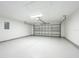 Bright and clean garage with neutral walls, concrete floor, and roll-up door at 2647 Lake Landing Blvd, Eustis, FL 32726