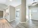 Beautifully decorated hallway with gray wood-look floors and open concept floor plan to the kitchen and front door at 2647 Lake Landing Blvd, Eustis, FL 32726