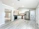 Bright kitchen featuring stainless appliances, white cabinets, and gray countertops at 2647 Lake Landing Blvd, Eustis, FL 32726