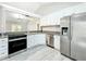 Modern kitchen with stainless steel appliances, white cabinets, and granite countertops at 2647 Lake Landing Blvd, Eustis, FL 32726
