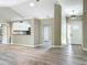 Open living space with kitchen view, modern flooring, and updated lighting fixtures at 2647 Lake Landing Blvd, Eustis, FL 32726