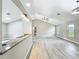Open living space with vaulted ceilings, breakfast bar, and wood-look floors at 2647 Lake Landing Blvd, Eustis, FL 32726
