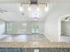 Spacious living room with bright lighting, gray wood-look floors, and access to backyard through beautiful french doors at 2647 Lake Landing Blvd, Eustis, FL 32726