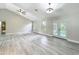 This living room boasts vaulted ceilings, lots of light, and wood-look flooring at 2647 Lake Landing Blvd, Eustis, FL 32726