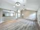 Bright living room boasts wood floors, vaulted ceiling, and a ceiling fan at 2647 Lake Landing Blvd, Eustis, FL 32726