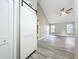 Living room featuring vaulted ceilings, windows, ceiling fan, and light wood floors at 2647 Lake Landing Blvd, Eustis, FL 32726