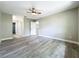 Spacious main bedroom with updated flooring, ceiling fan, and base trim at 2647 Lake Landing Blvd, Eustis, FL 32726