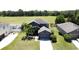 Aerial view of a two-story house with an attached garage, lush lawn and tall green trees at 2865 Running Brook Cir, Kissimmee, FL 34744