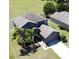 Aerial view of a grey two-story home with lush green grass, palm trees, and a large lawn at 2865 Running Brook Cir, Kissimmee, FL 34744