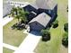 An aerial shot of a two-story home featuring an attached garage and driveway in a manicured neighborhood at 2865 Running Brook Cir, Kissimmee, FL 34744