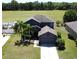 A beautiful two-story home has a well-manicured lawn, mature palm trees, and a two-car garage at 2865 Running Brook Cir, Kissimmee, FL 34744
