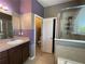 Bathroom with granite countertops, double vanity, and a spacious shower at 2865 Running Brook Cir, Kissimmee, FL 34744