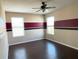 Spacious bedroom with modern flooring, a ceiling fan, and two windows allowing for natural light at 2865 Running Brook Cir, Kissimmee, FL 34744