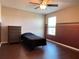 Bedroom with dark laminate flooring, a ceiling fan, and natural light from the window at 2865 Running Brook Cir, Kissimmee, FL 34744