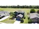 Two-story home featuring an attached garage and well-manicured lawn with palm trees and a large field in the background at 2865 Running Brook Cir, Kissimmee, FL 34744