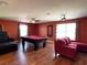 Spacious game room with a pool table, ceiling fan and recessed lighting with windows for plenty of natural light at 2865 Running Brook Cir, Kissimmee, FL 34744