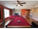 Game room showcasing a pool table with a bright red top, lots of space for entertaining and dark laminate floors at 2865 Running Brook Cir, Kissimmee, FL 34744