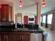 An inviting kitchen with stainless steel appliances, granite countertops, and an open view into Gathering room at 2865 Running Brook Cir, Kissimmee, FL 34744