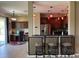 Modern kitchen with dark cabinets, stainless steel appliances, and a breakfast bar with pendant lighting at 2865 Running Brook Cir, Kissimmee, FL 34744