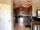 Modern kitchen with stainless steel appliances, granite countertops, and warm, inviting pendant lighting at 2865 Running Brook Cir, Kissimmee, FL 34744