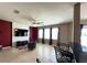 Stylish living room with tile flooring, accent walls, and large windows, adjacent to the kitchen and dining area at 2865 Running Brook Cir, Kissimmee, FL 34744