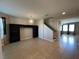 Open-concept living room with tile flooring, a decorative chandelier, and easy access to other living spaces at 2865 Running Brook Cir, Kissimmee, FL 34744