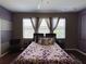 Charming main bedroom with hardwood floors, ceiling fan, and bright natural light from two large windows at 2865 Running Brook Cir, Kissimmee, FL 34744
