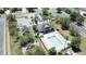 Aerial view of the community pool, playground, and neighborhood with palm trees and lush foliage at 2865 Running Brook Cir, Kissimmee, FL 34744