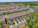 A high angle view of townhomes in a community with a pond and water feature surrounded by mature trees at 3039 Springwell Loop, Orlando, FL 32808