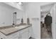 Bright bathroom features a modern sink with storage below and a large mirror with a closet visible in the background at 3039 Springwell Loop, Orlando, FL 32808
