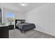 Comfortable bedroom featuring a window, carpeted floors, and a modern nightstand at 3039 Springwell Loop, Orlando, FL 32808