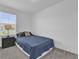 Cozy bedroom with carpeted floors, a large window, and a comfortable bed at 3039 Springwell Loop, Orlando, FL 32808