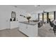 Open kitchen and dining area featuring a granite island, tiled floor, and natural light at 3039 Springwell Loop, Orlando, FL 32808