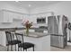 Modern kitchen with granite countertops, stainless steel refrigerator, and white cabinetry at 3039 Springwell Loop, Orlando, FL 32808