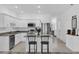 Bright kitchen featuring an island with granite countertops, stainless appliances, and tiled floor at 3039 Springwell Loop, Orlando, FL 32808